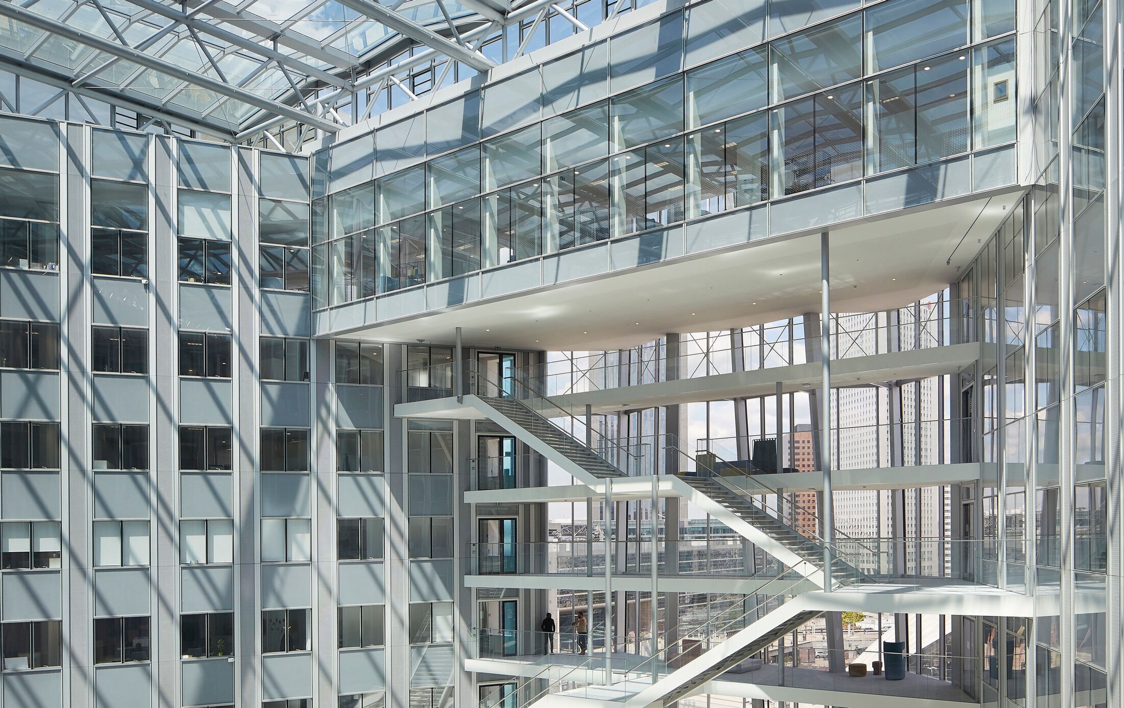 a large building with a glass roof and stairs