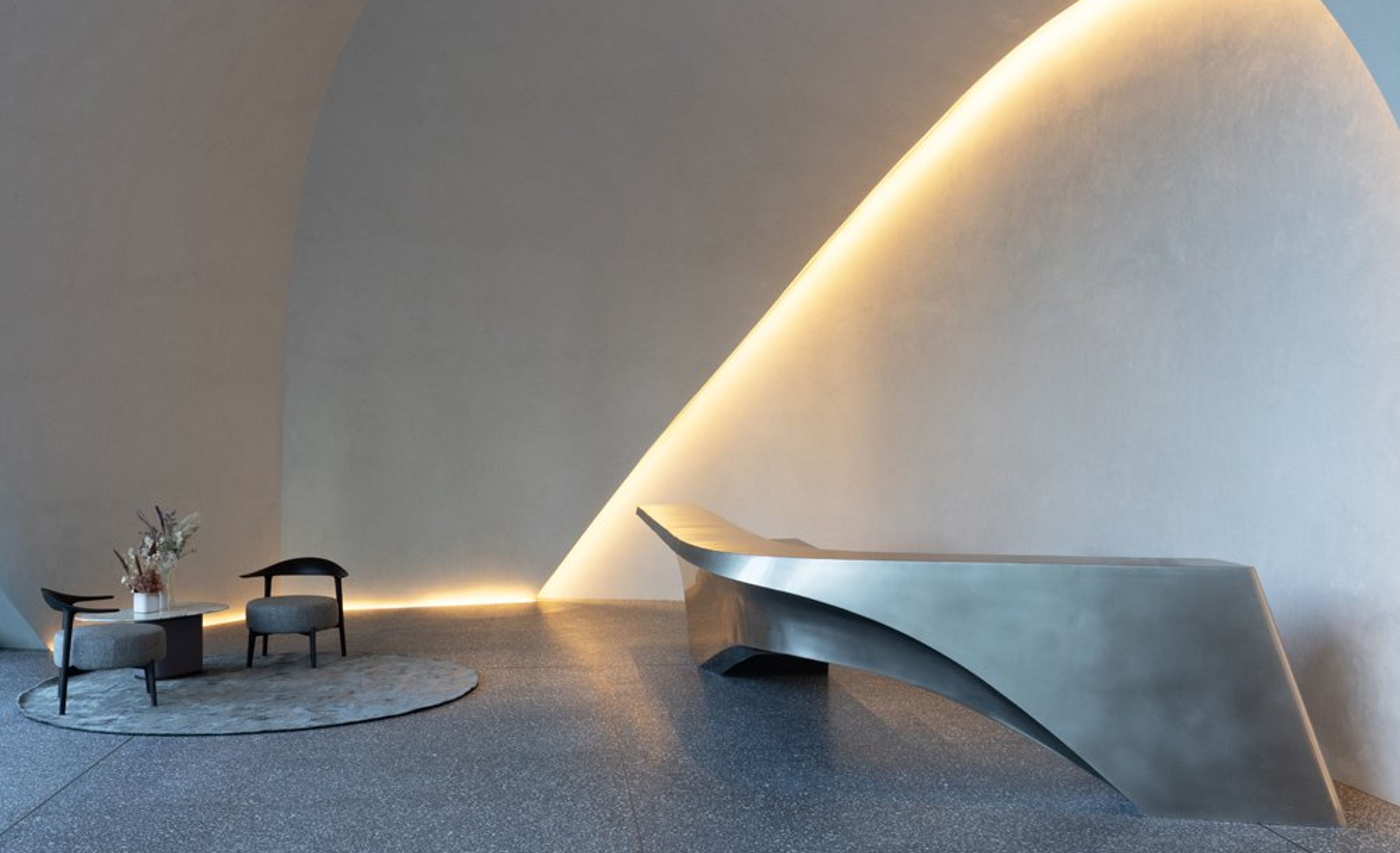 a room with a curved ceiling and a curved table