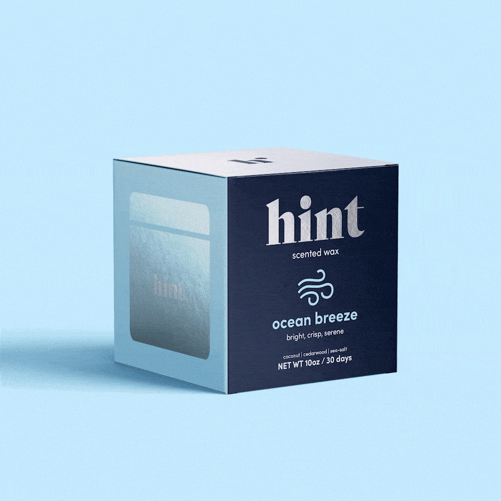 Animated image of Hint’s scented wax box rotating on a light background, featuring minimalist branding and product details in white and silver text.