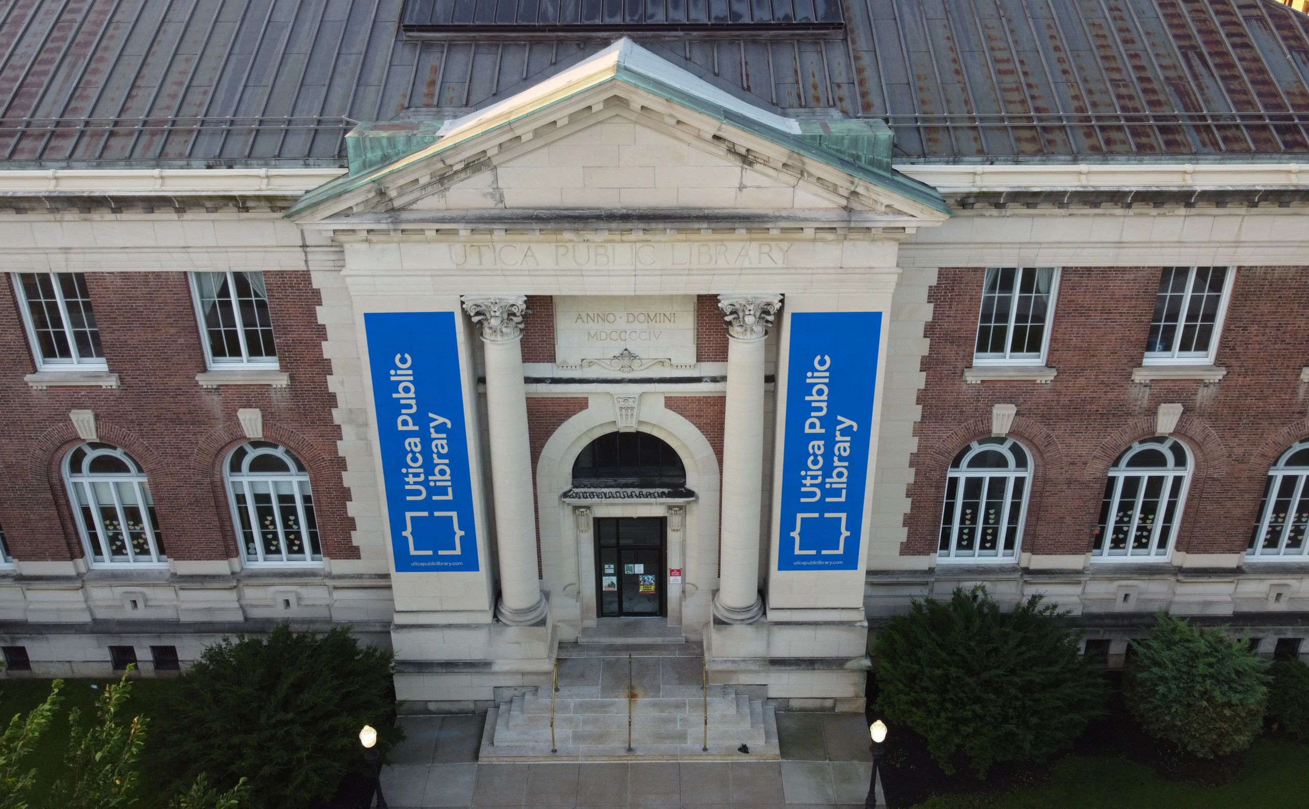 Front of a library building with banners.