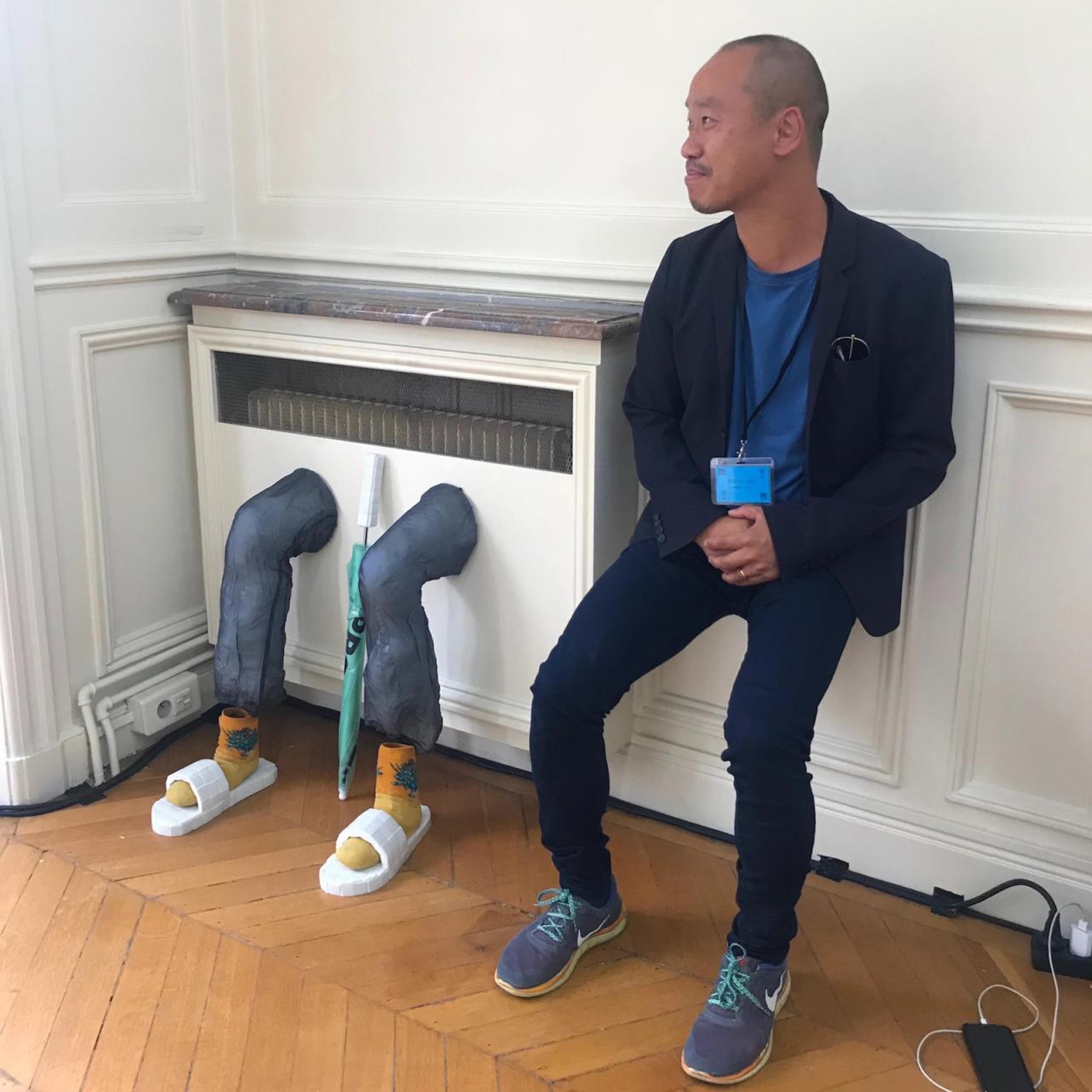 Gallerist Joseph Tang showing empathy for a sculpture by Adam Cruces &amp; Louisa Gagliardi