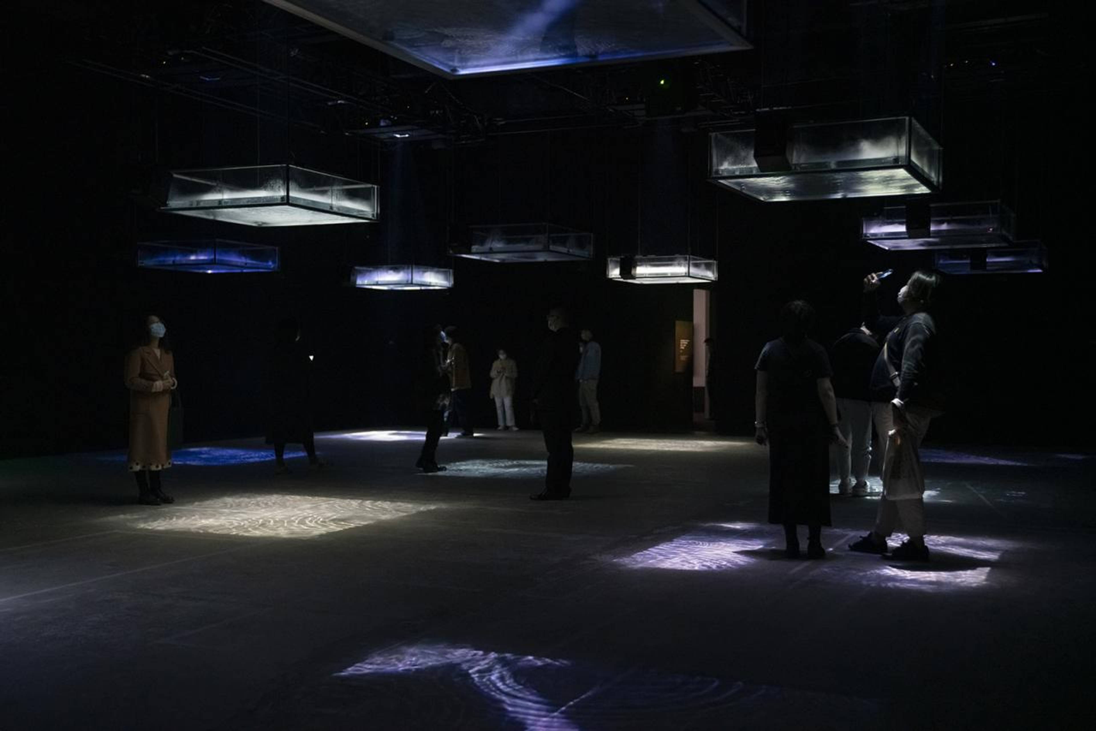 Ryuichi Sakamoto + Shiro Takatani, LIFE - fluid, invisible, inaudible..., 2007/2021, Installation,  24 channel audio, 12 acrylic water tanks with ultrasonic fog generators and video projectors, courtesy M Woods Museum