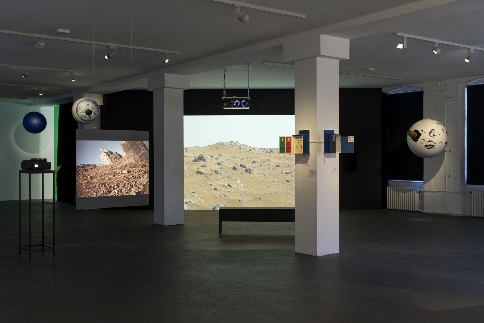 Front (column): Tsuyoshi Ozawa with Andreas Eberlein, Dagmar Tinschmann, Daisuke Deguchi, Jinran Kim, Kathrin Schiff bauer, Li Koelan, Manuela Warstat, Yuan Shun, New Nasubi Gallery, 1993. © Tsuyoshi Ozawa, © VG Bild-Kunst, Bonn 2025 for Dagmar Tinschmann-Lichtefeld, Kathrin Schiffbauer, Manuela Warstat and Yuan Shun; Back (videos and installation): Etcétera, LIBERATE MARS, 2025. © Etcétera. Installation view, 13th Berlin Biennale, KW Institute for Contemporary Art, 2025. Photo: Diana Pfammatter, Eike Walkenhorst