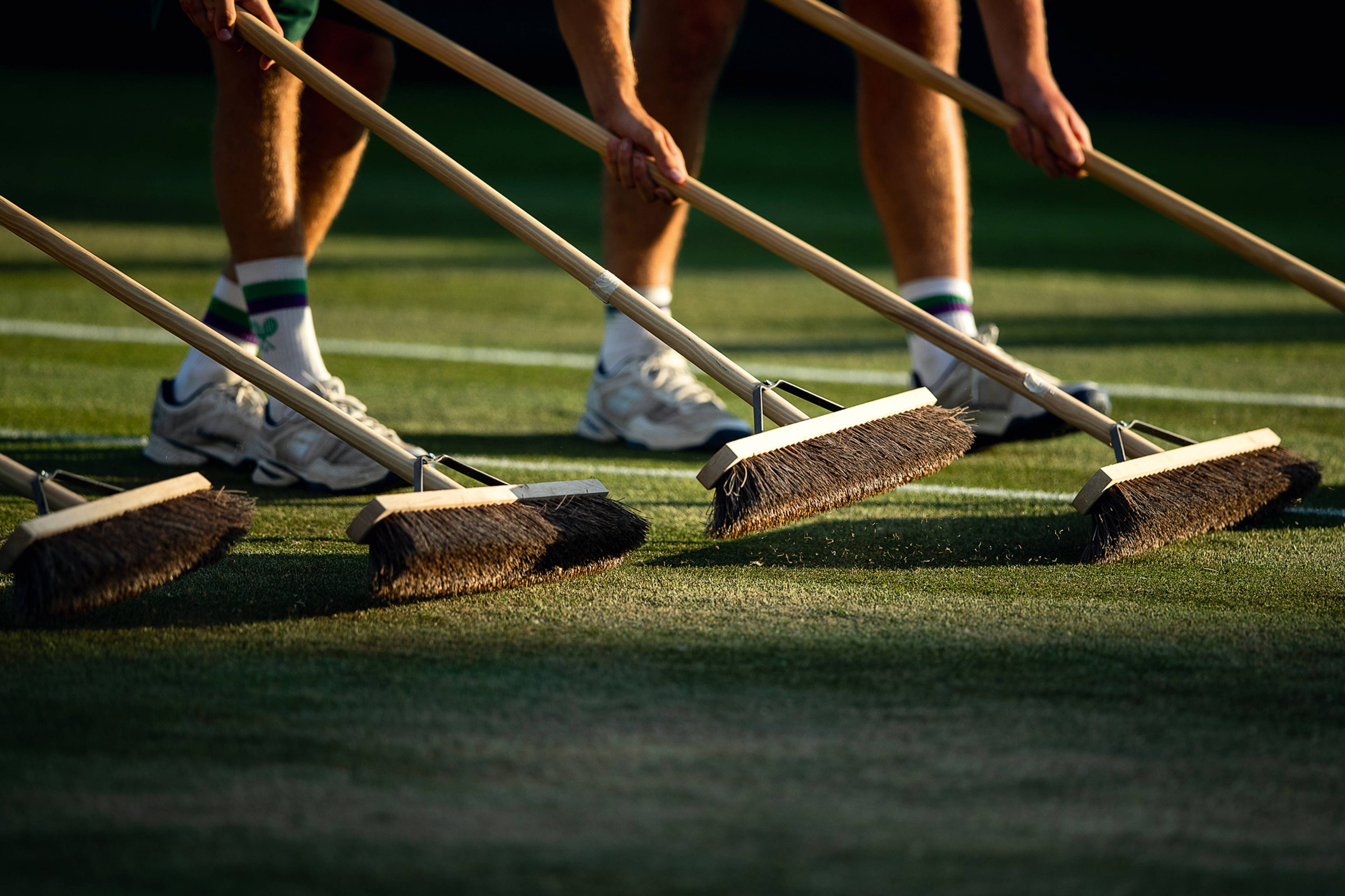 Groundstaff brooming the courts