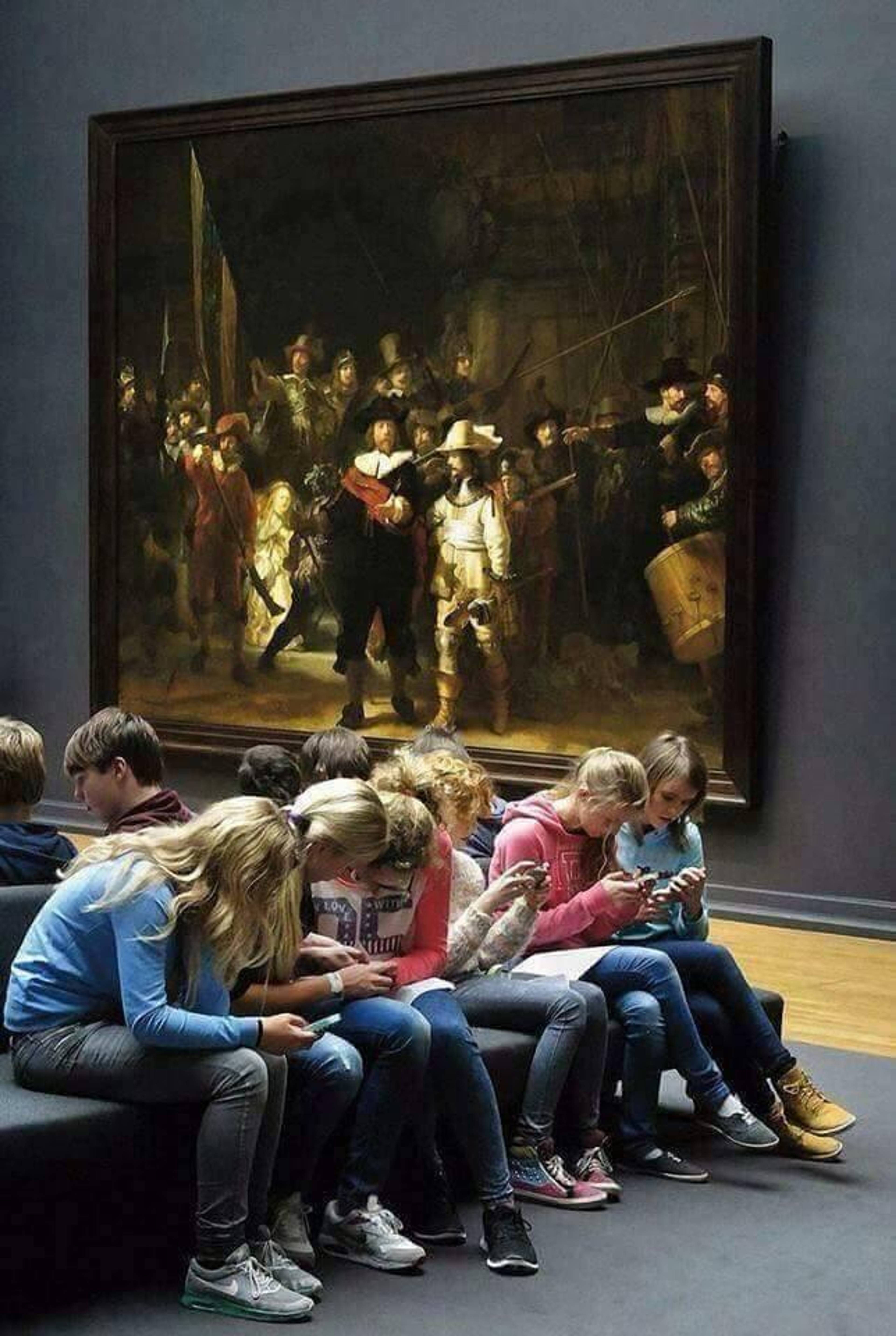 Museum visitors on their phones