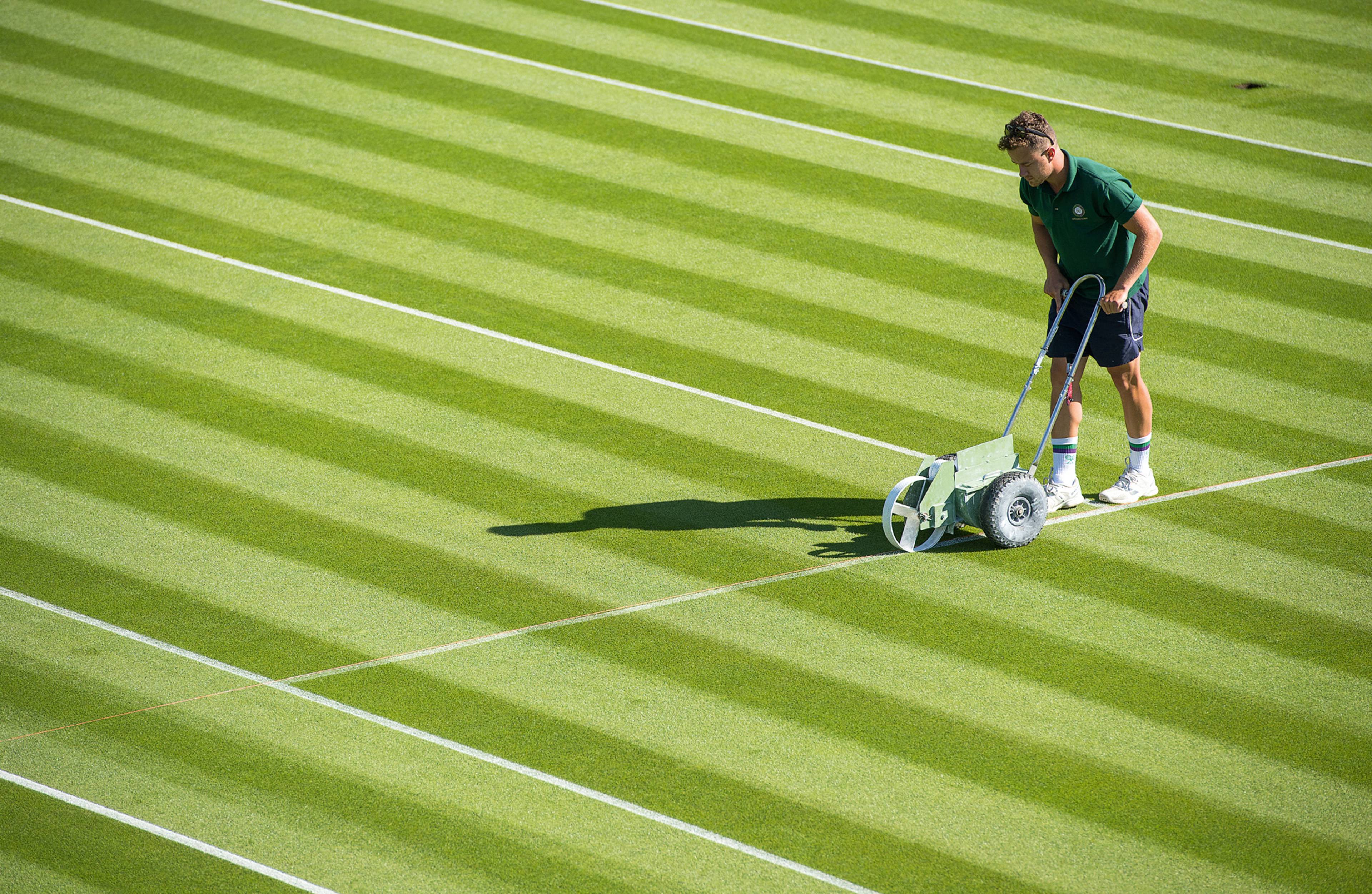 A groundsman marking out lines