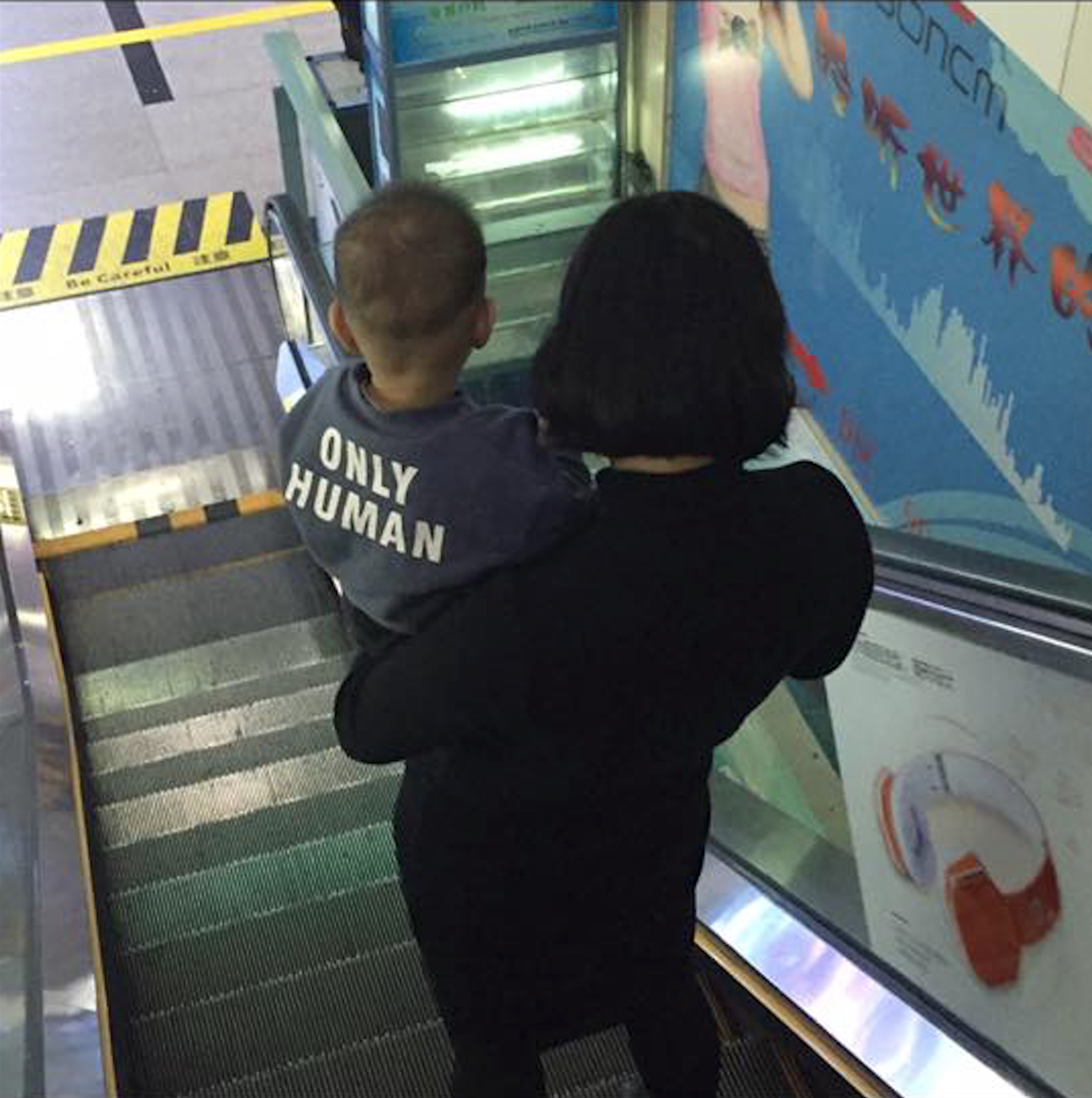 “Only human” kids shirt on escalator