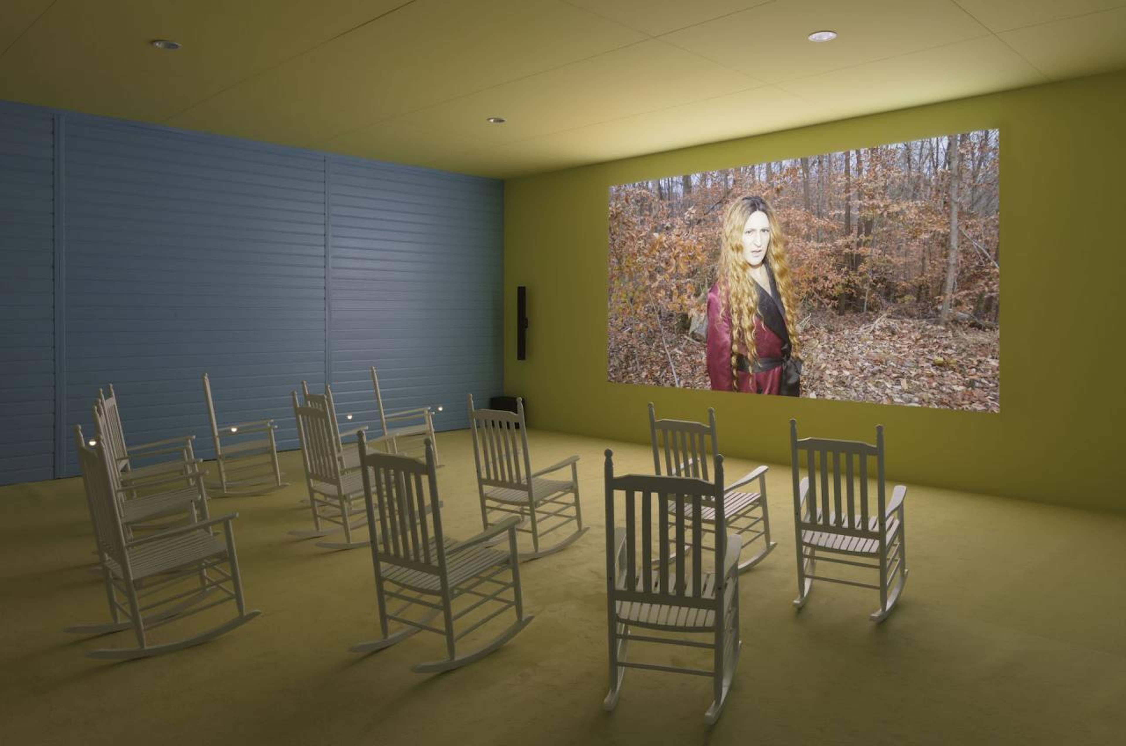 Exhibition view of &ldquo;Lizzie Fitch | Ryan Trecartin: Whether Line&rdquo;, Fondazione Prada, 2019 Photo Andrea Rossetti, Courtesy Fondazione Prada Lizzie Fitch | Ryan Trecartin Plot Front, 2019 4K video, color, sound, 1hr 45min approx. Wood, sheet metal, carpet, perforated metal acoustical panels, drywall, paint, PVC siding, bituminous sheath, rockers, lights, ambient sound