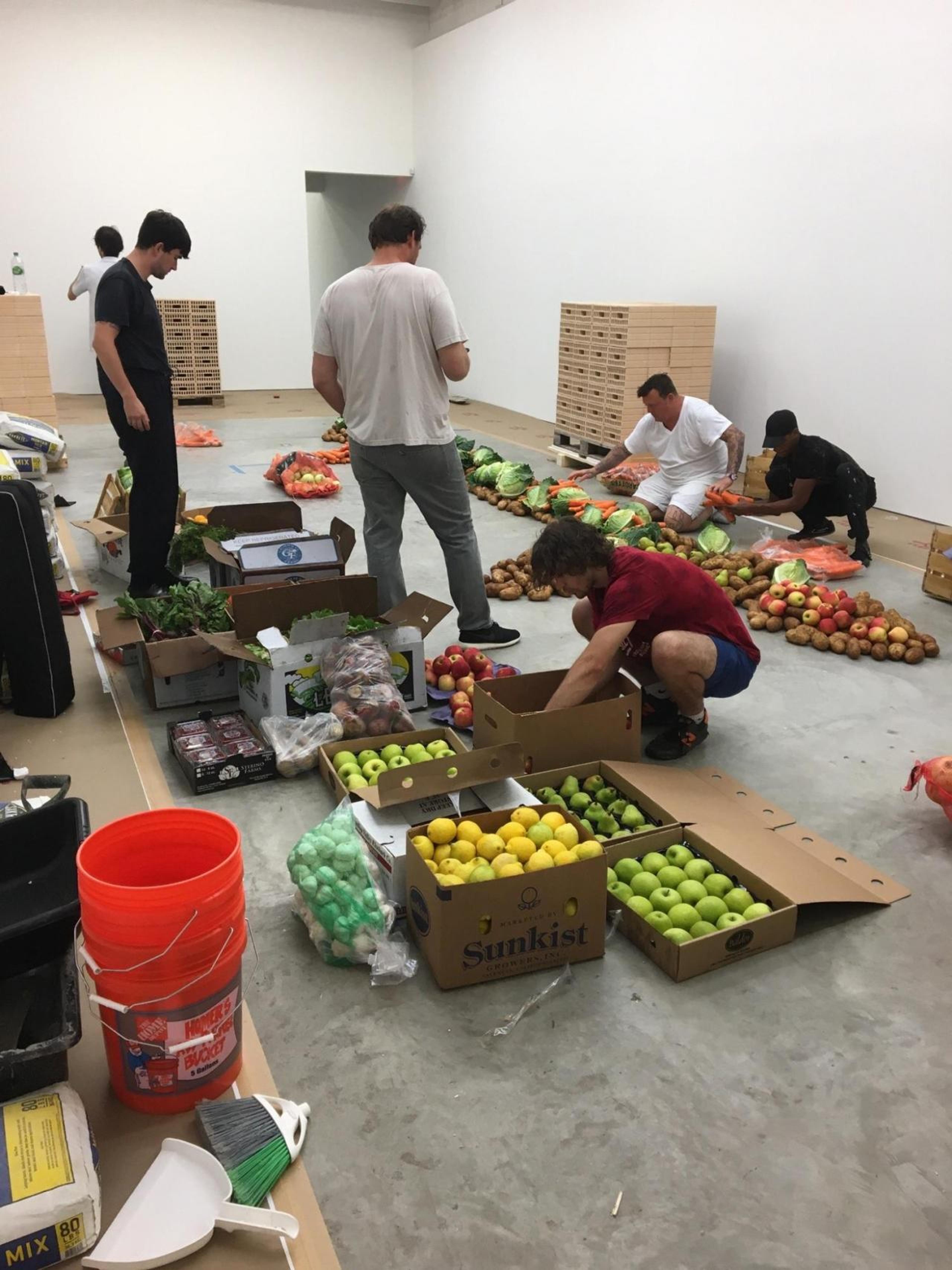 Handling produce for an Urs Fischer installation.