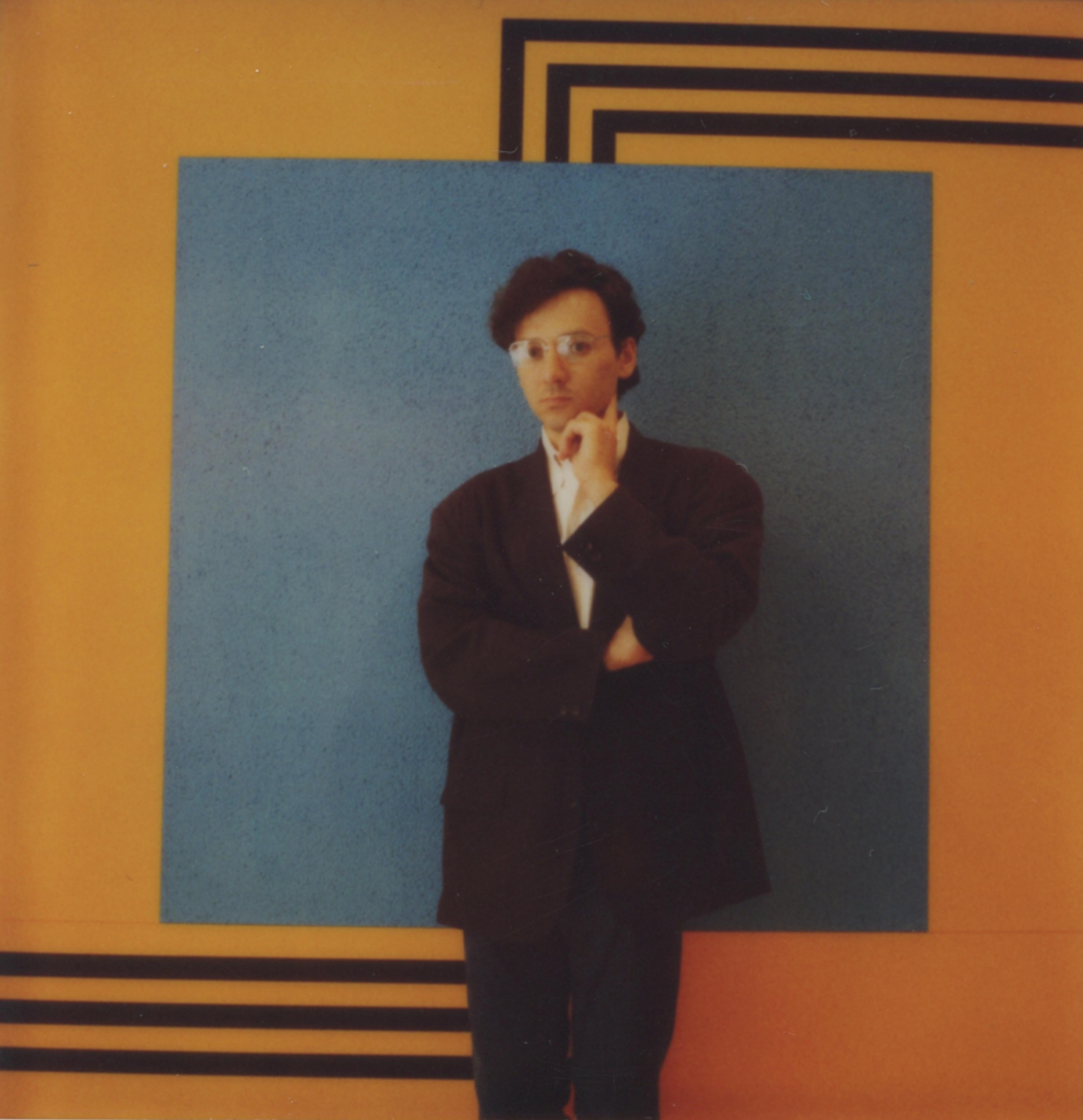 Portrait of Peter Halley in front of Blue Cell with Triple Conduit 3, Polaroid, 1986