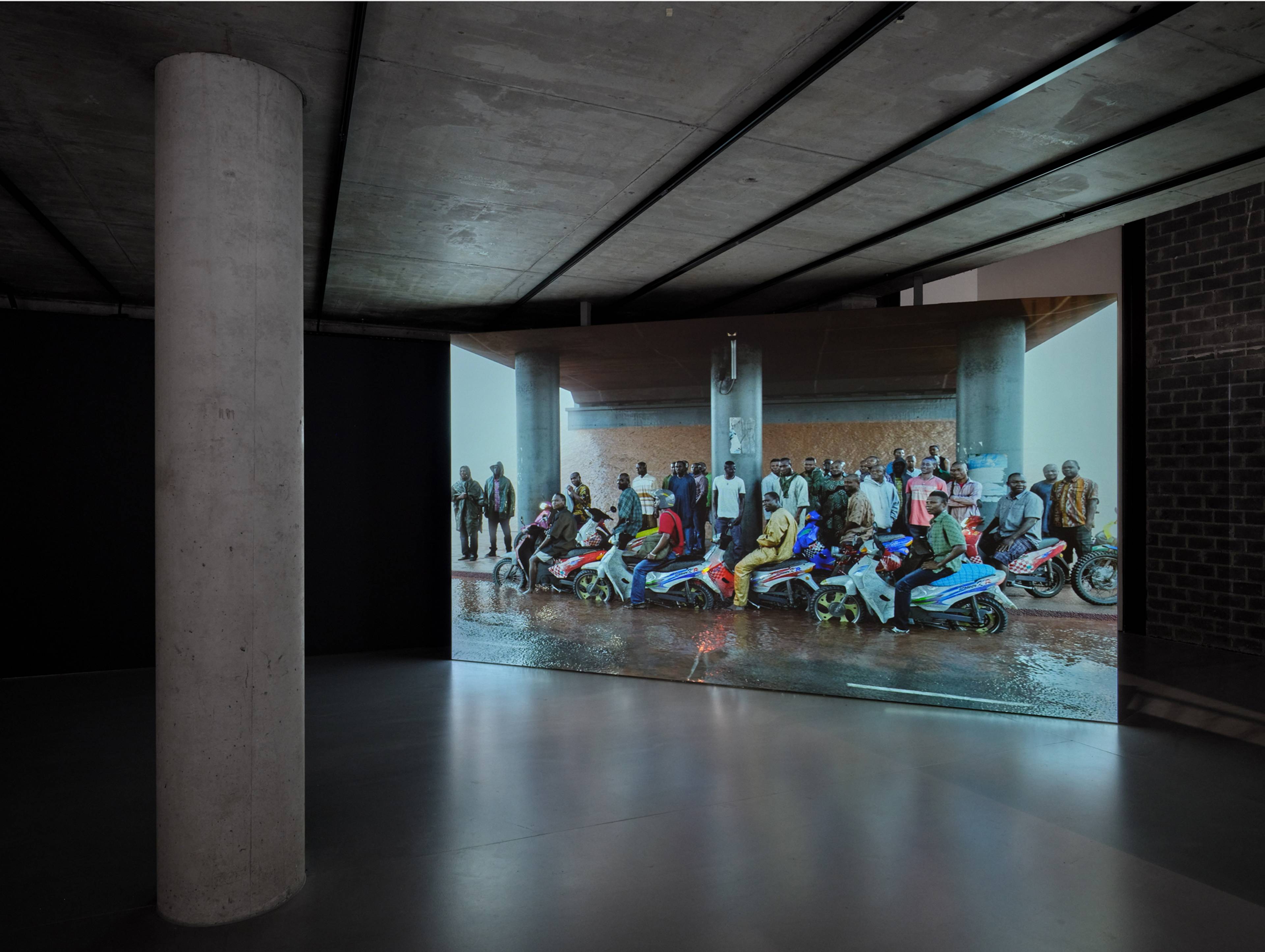 David Claerbout, Oil workers (from the Shell company of Nigeria) returning home from work, caught in torrential rain, 2013