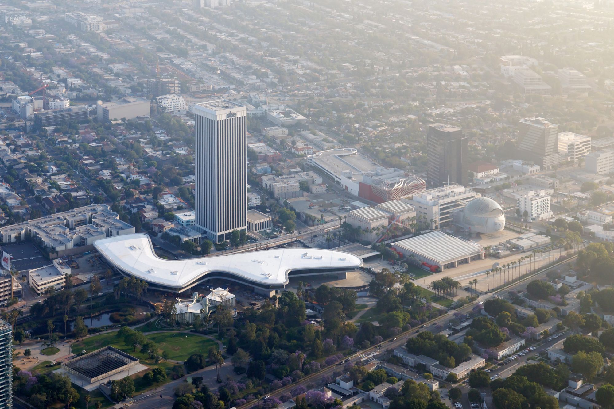 Aerial view of LACMA buildings, including David Geffen Galleries in context of Miracle Mile