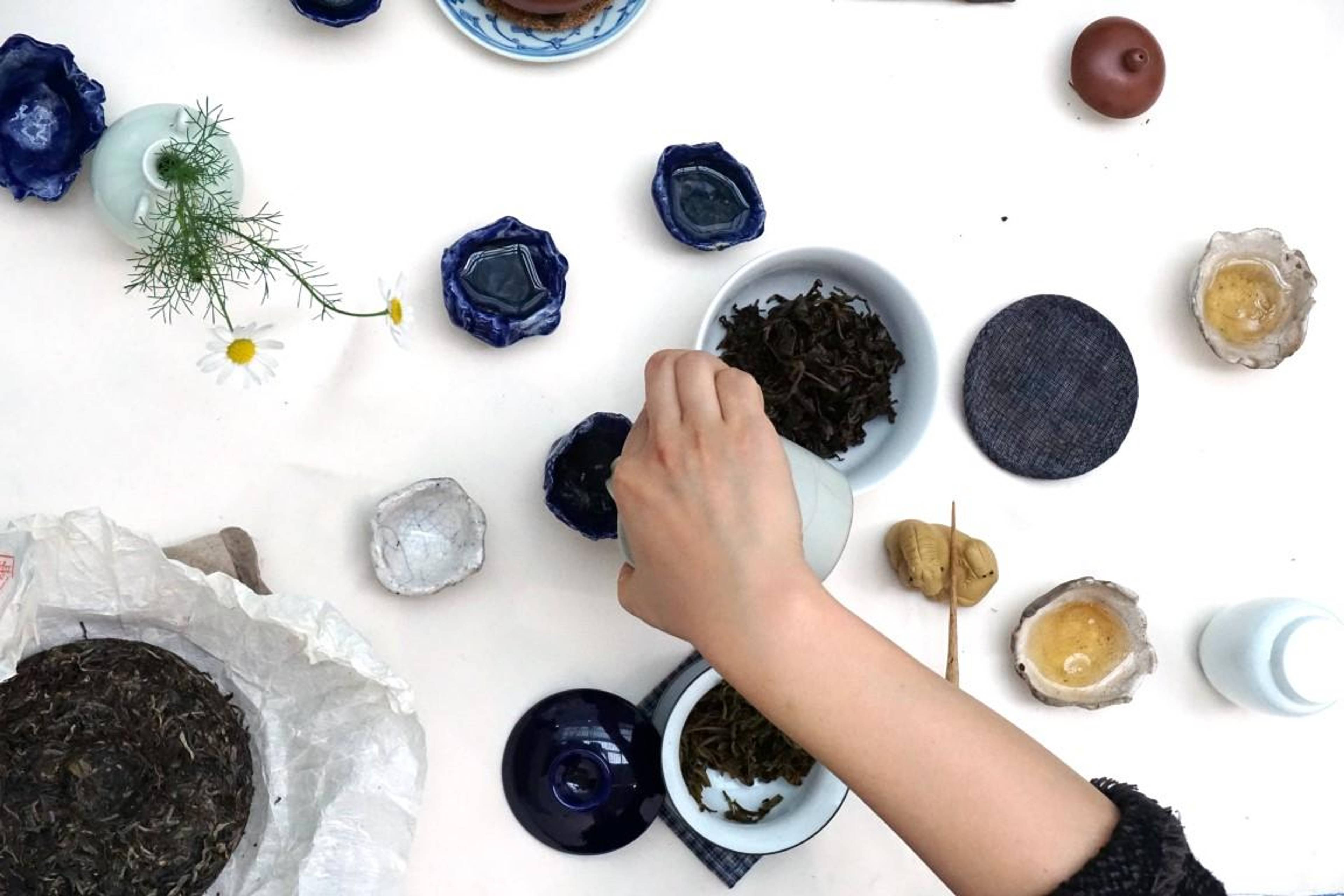 Ying-Le serving special handcrafted tea in Raku ceramic tea cups made by Reto Pulver during a performance inside Reto Pulver&#39;s installation at Fiac, Paris, 2015.  Photo: Reto Pulver