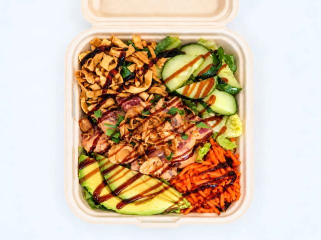 Aloha Salads Poke Salad with spicy ahi, avocado, cucumber, carrots, and crispy onion