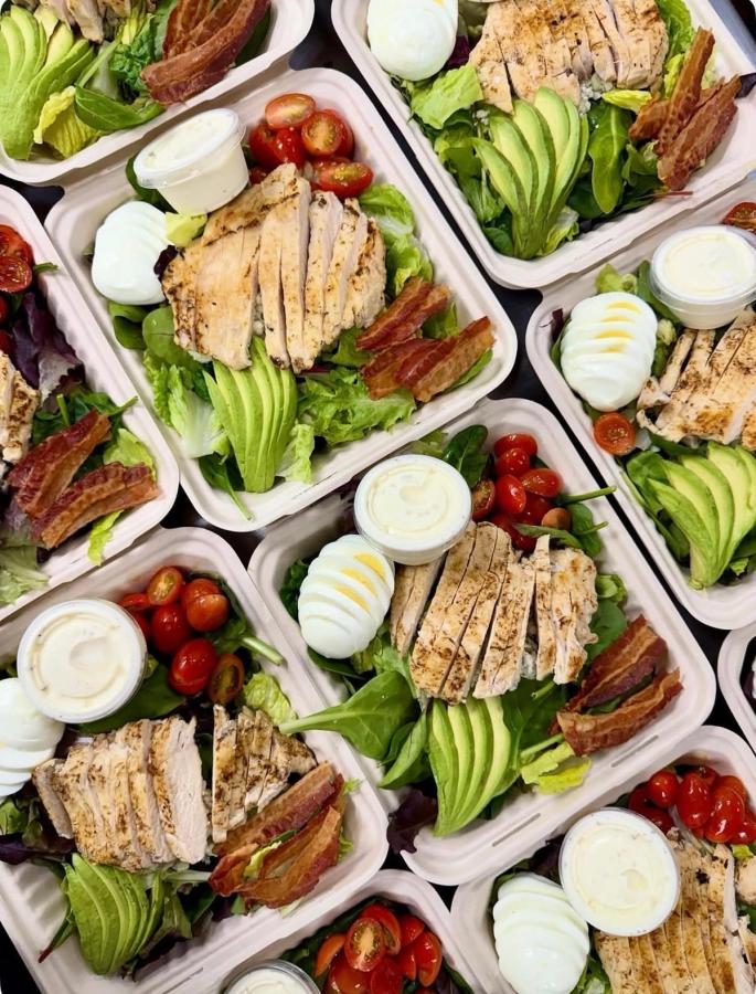 Signature salad bowls from Aloha Salads with grilled chicken, avocado, bacon, egg, and tomatoes