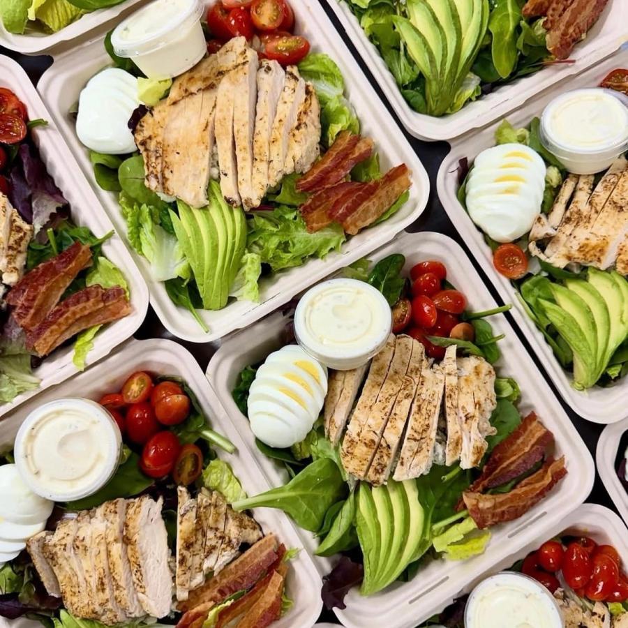 Signature salad bowls from Aloha Salads with grilled chicken, avocado, bacon, egg, and tomatoes Signature salad bowls from Aloha Salads with grilled chicken, avocado, bacon, egg, and tomatoes