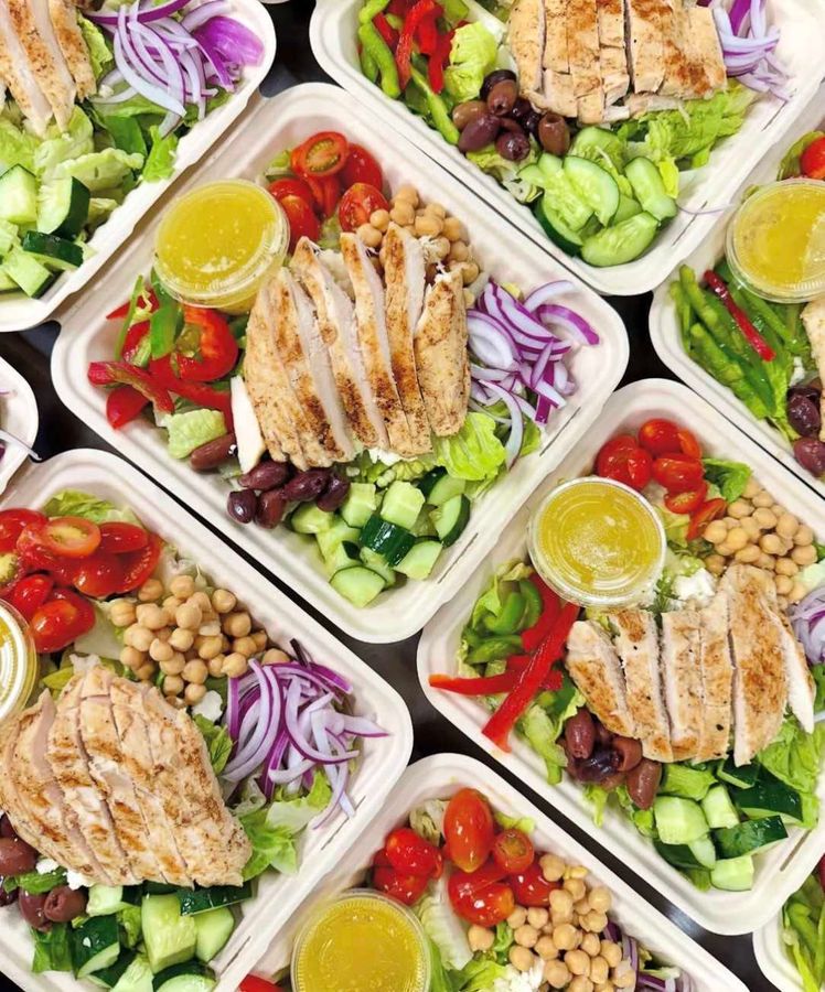 Individual salad bowls prepared for meeting catering