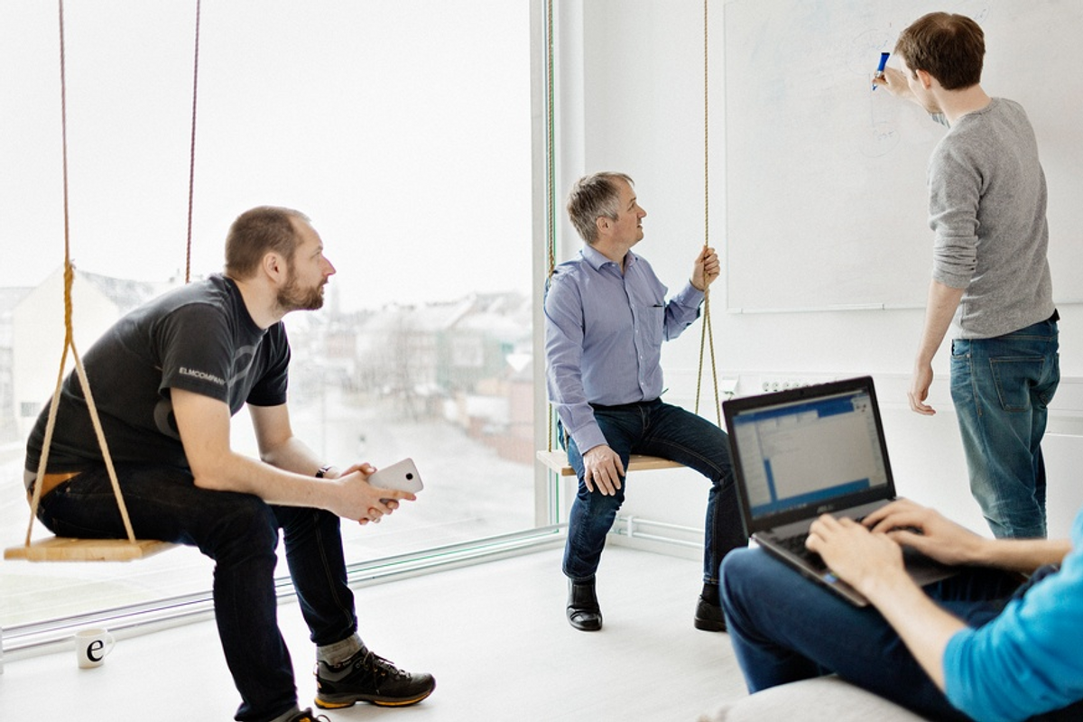 fire menn som følger med på en tavle