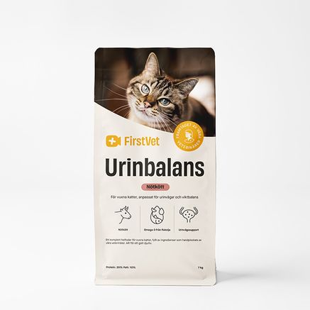 Påse med kattmaten FirstVet Urinbalans 7 kg. Med en bild på en fläckig katt. Påsen har gula detaljer.