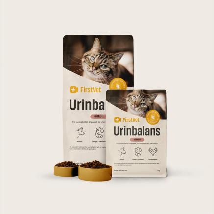 Påsar med kattmat från FirstVet Urinbalans. Med gula, fyllda matskålar framför.