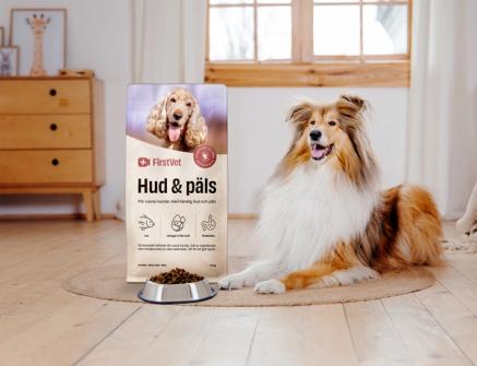 En bild på hundmaten "Hud & Päls" från FirstVet med en colliehund bredvid