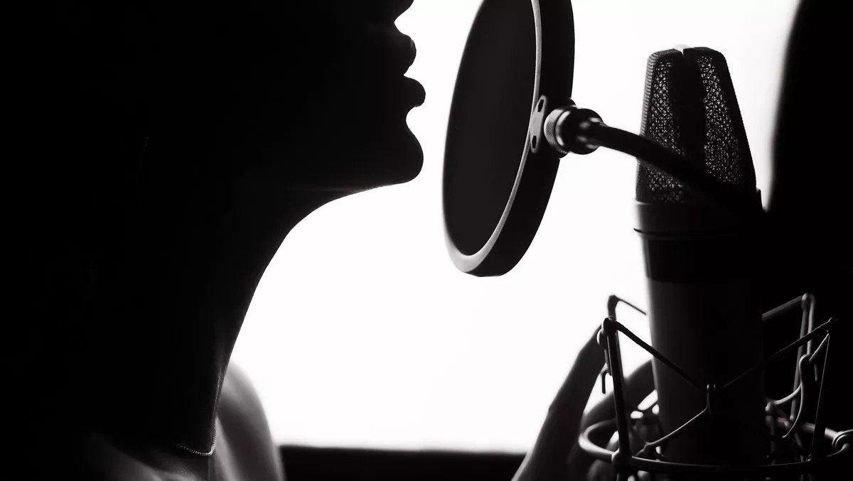 Female vocalist performing with a microphone in hand.