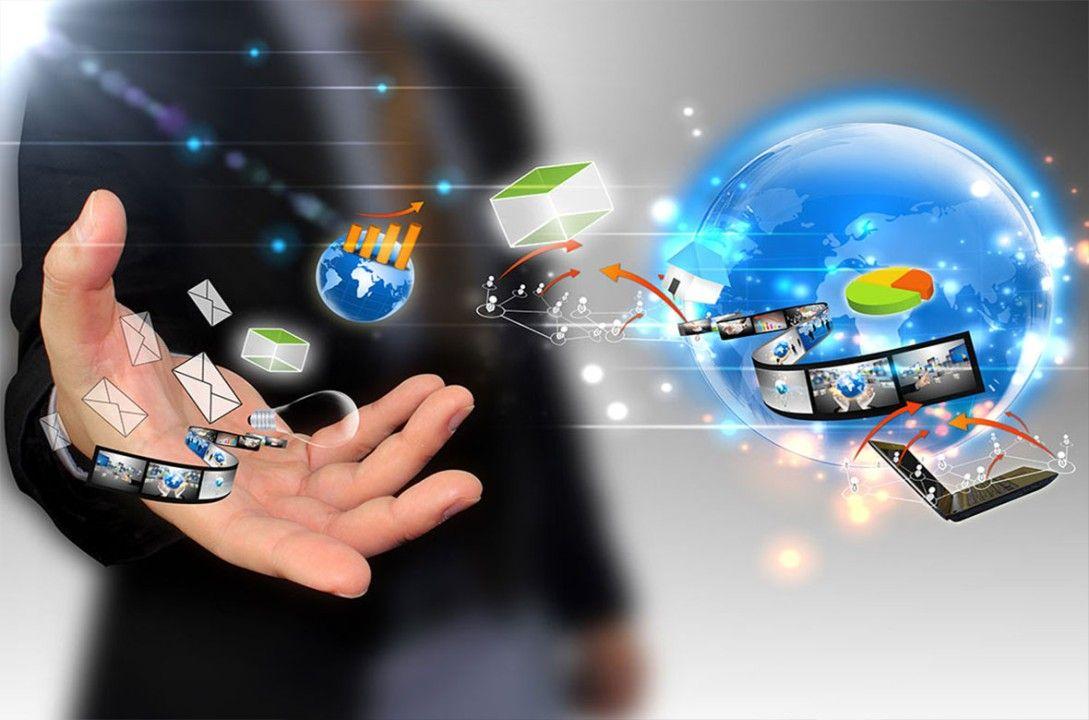 A man in a suit and tie holding a globe, representing the internet, with technology radiating from his hand.