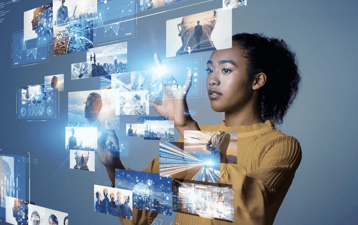 A woman interacting with a screen displaying multiple images.