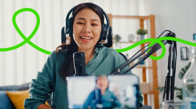 A woman wearing headphones and holding a phone, engrossed in her music and conversation.