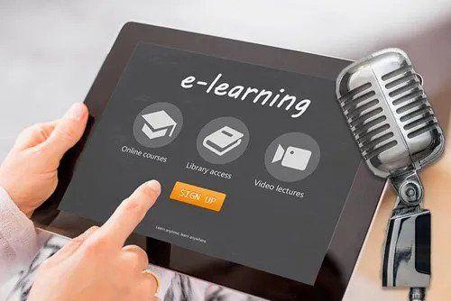 Hands of a woman holding a tablet showing e-learning choices like online courses and video lectures, with a microphone in view.