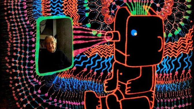 Noam Chomsky in a room with a neon sign, facing a camera-like image.