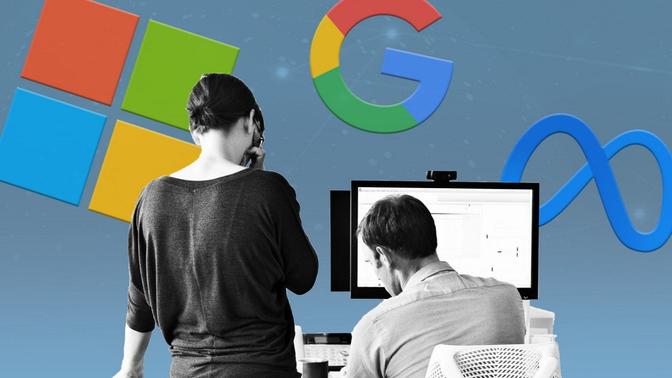Two individuals using computers with the Google, Meta & Microsoft logos displayed on the wall. 
