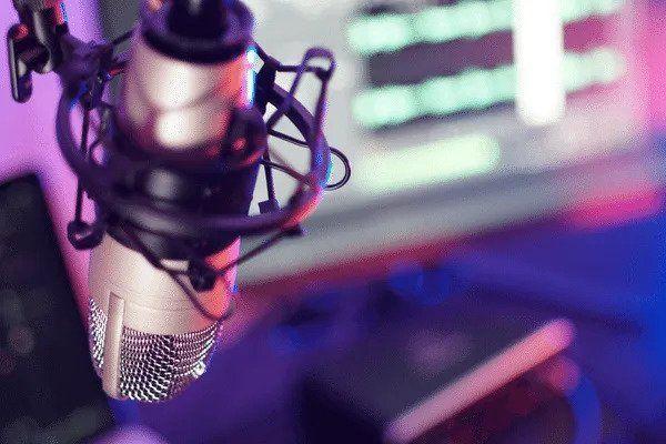 Close-up of a studio microphone in front of a computer.