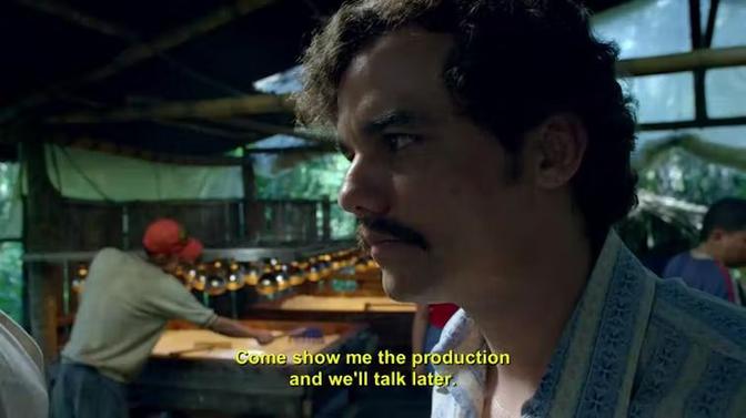 A man's intense gaze is fixed on something in the background, a scene from Narcos on Netflix.