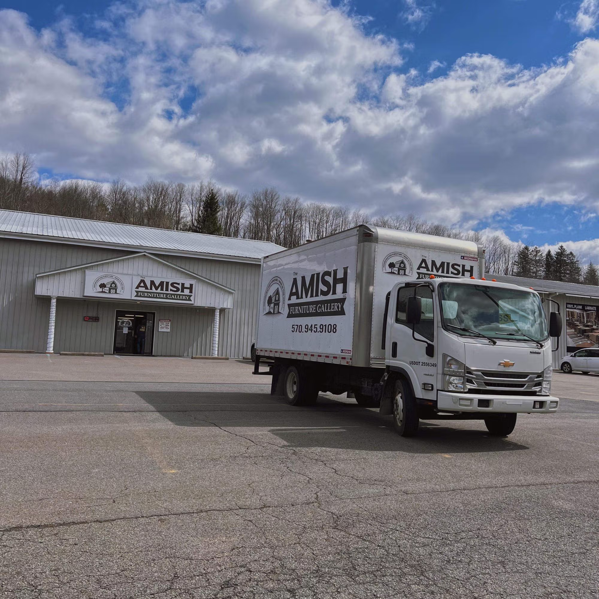 warm satin finish hardwood Visit our Factoryville showroom. anchoring a Factoryville floor scene with sunlit lighting.