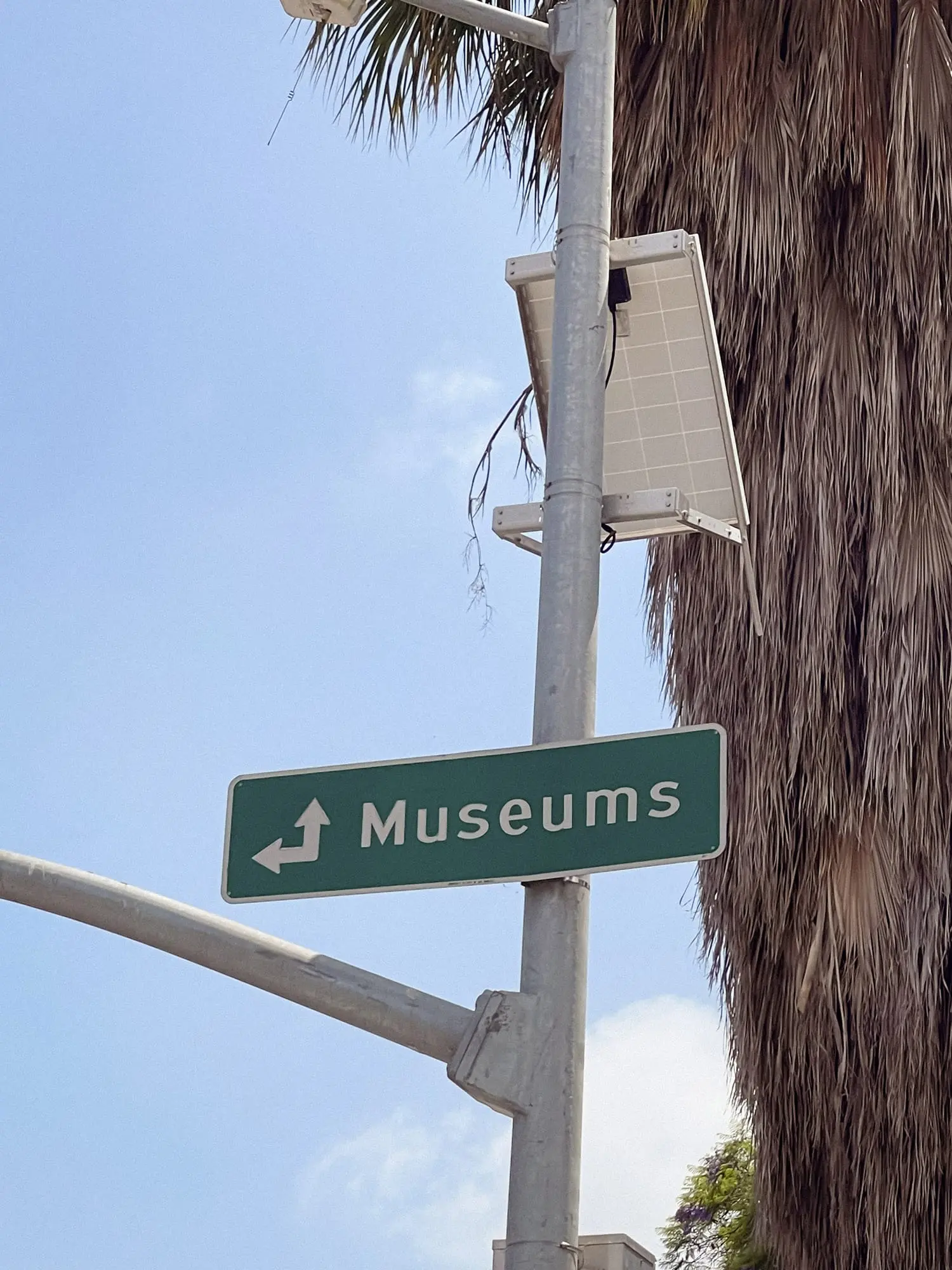 A street sign that says "Museums" and points in multiple directions