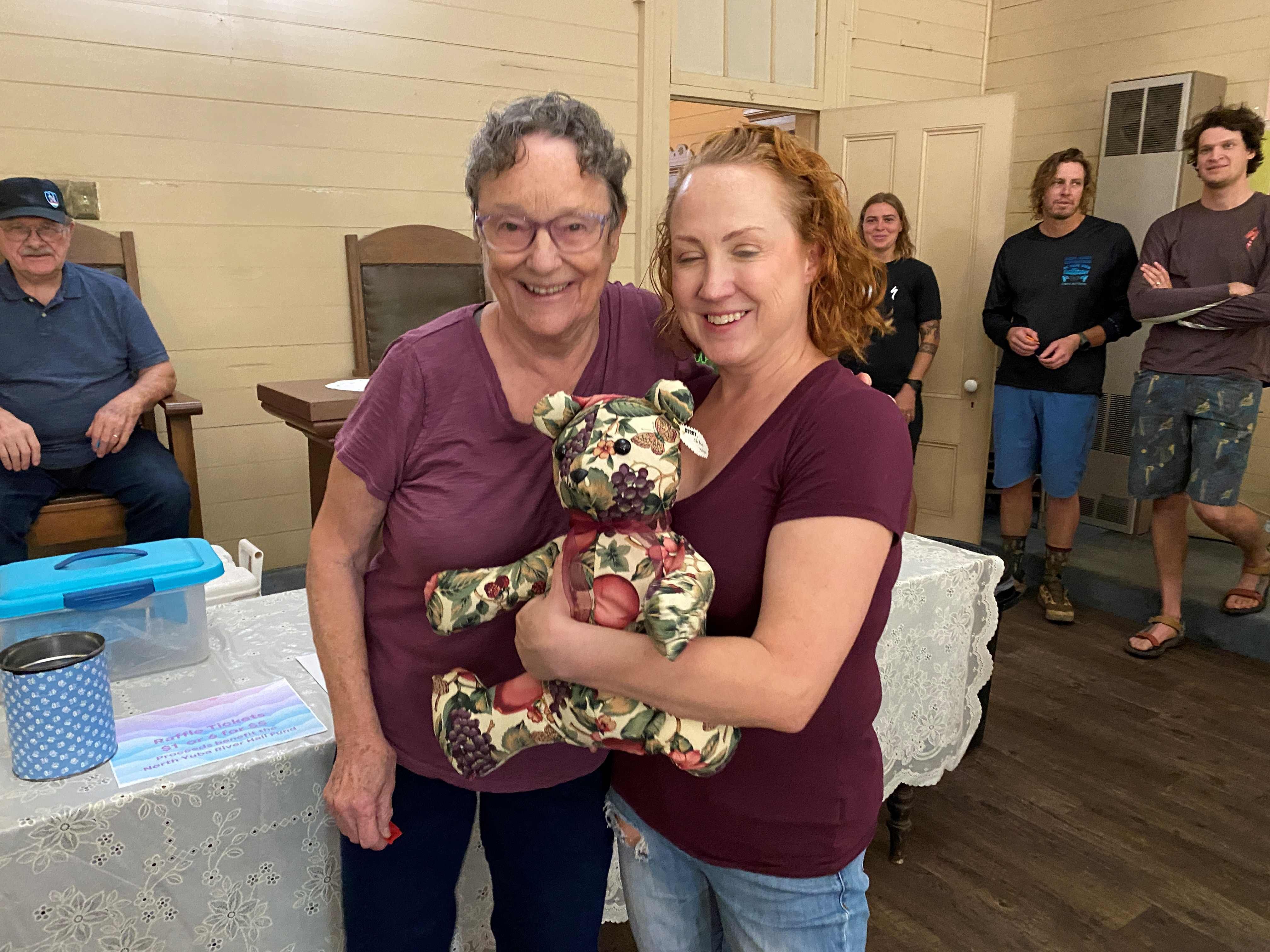 (Left to right) Ingrid Larson presents Berry Bear to Danielle Williamson
