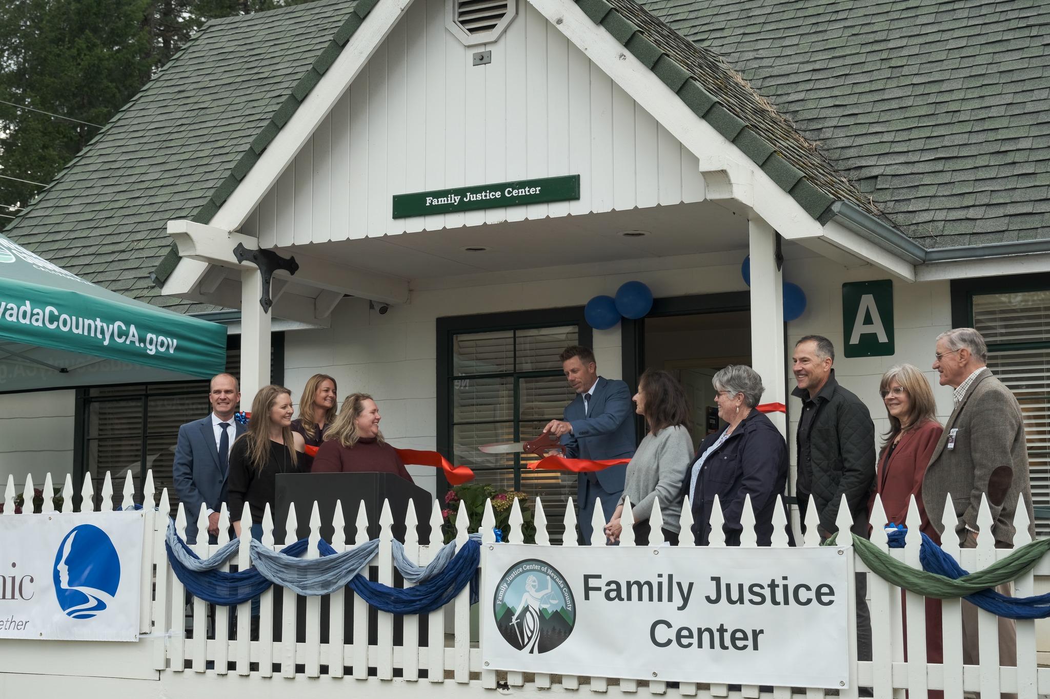 District Attorney Jesse Wilson is cuts the ribbon in front of the Family Justice Center beside community leaders and partners. Credit: Nevada County District Attorney’s Office / Facebook.