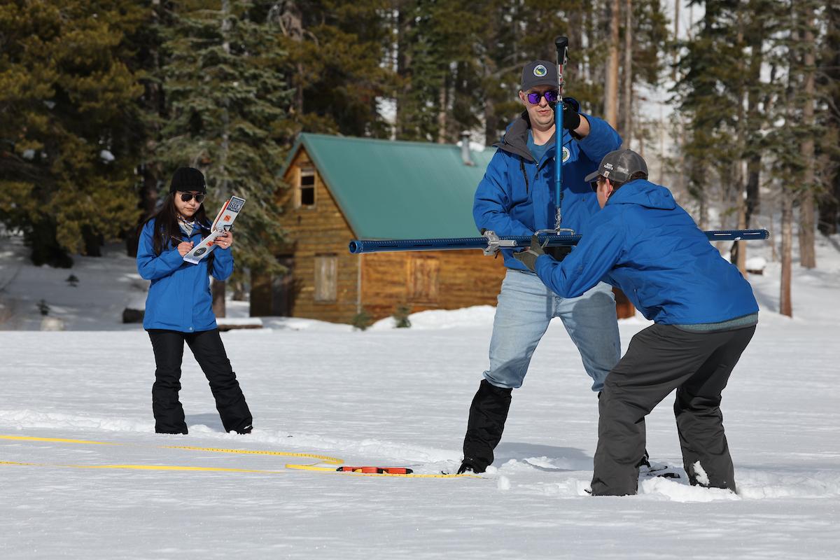 DWR scientists conduct the agency’s manual snowpack survey.