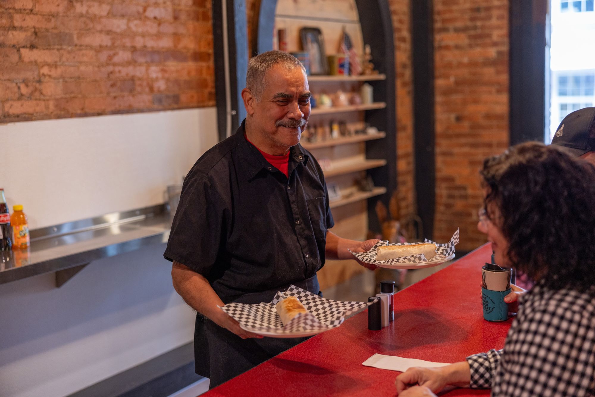 John Perez serves customers at the newly opened JADAA's Kitchen location