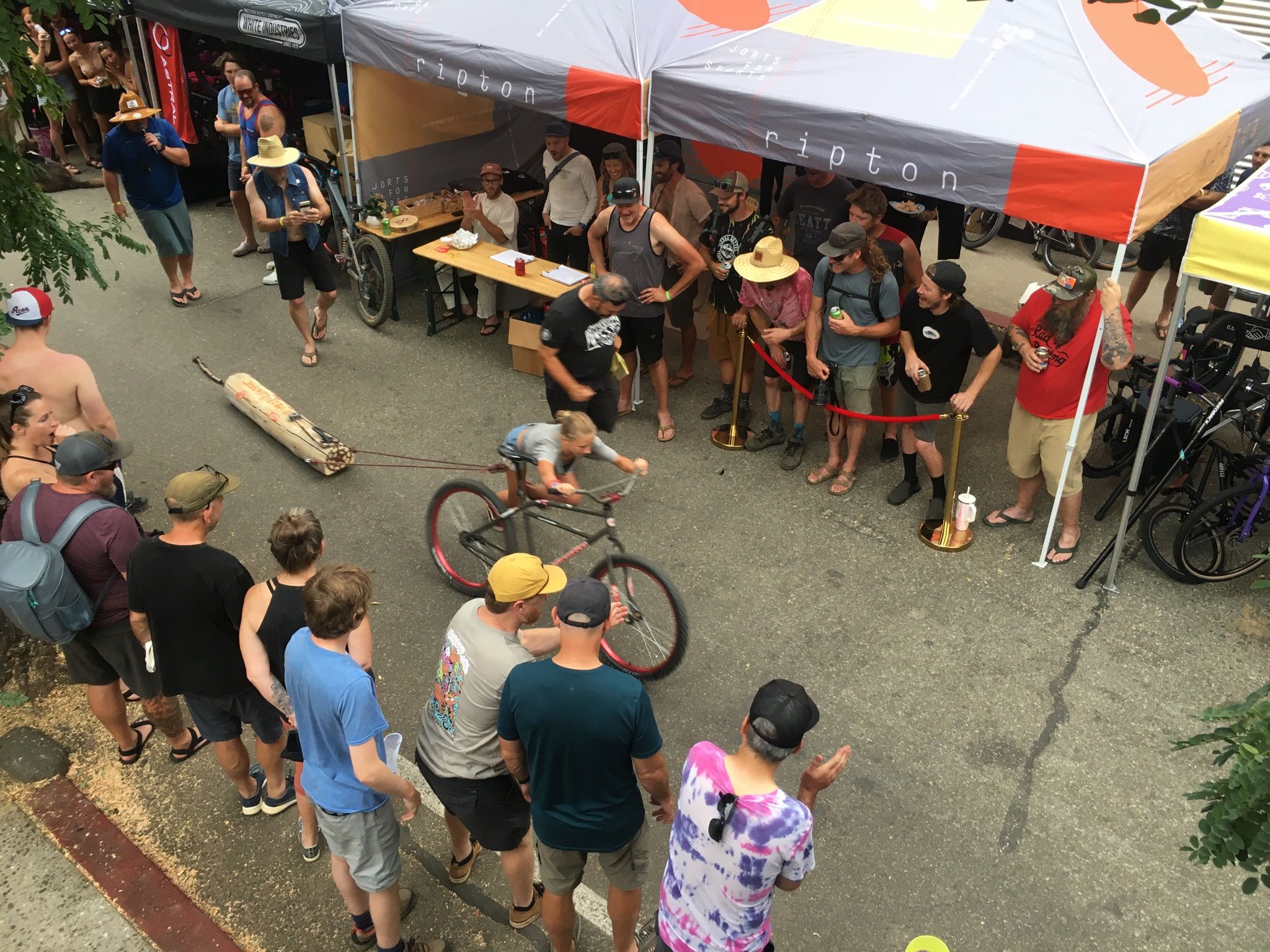 A local pushes the bike along in the Log Pull competition