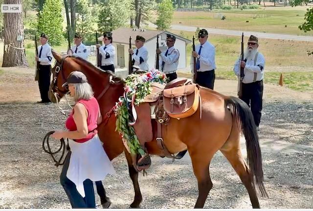 The riderless horse with the honor guard in the background. Photo by Linda Cooley.