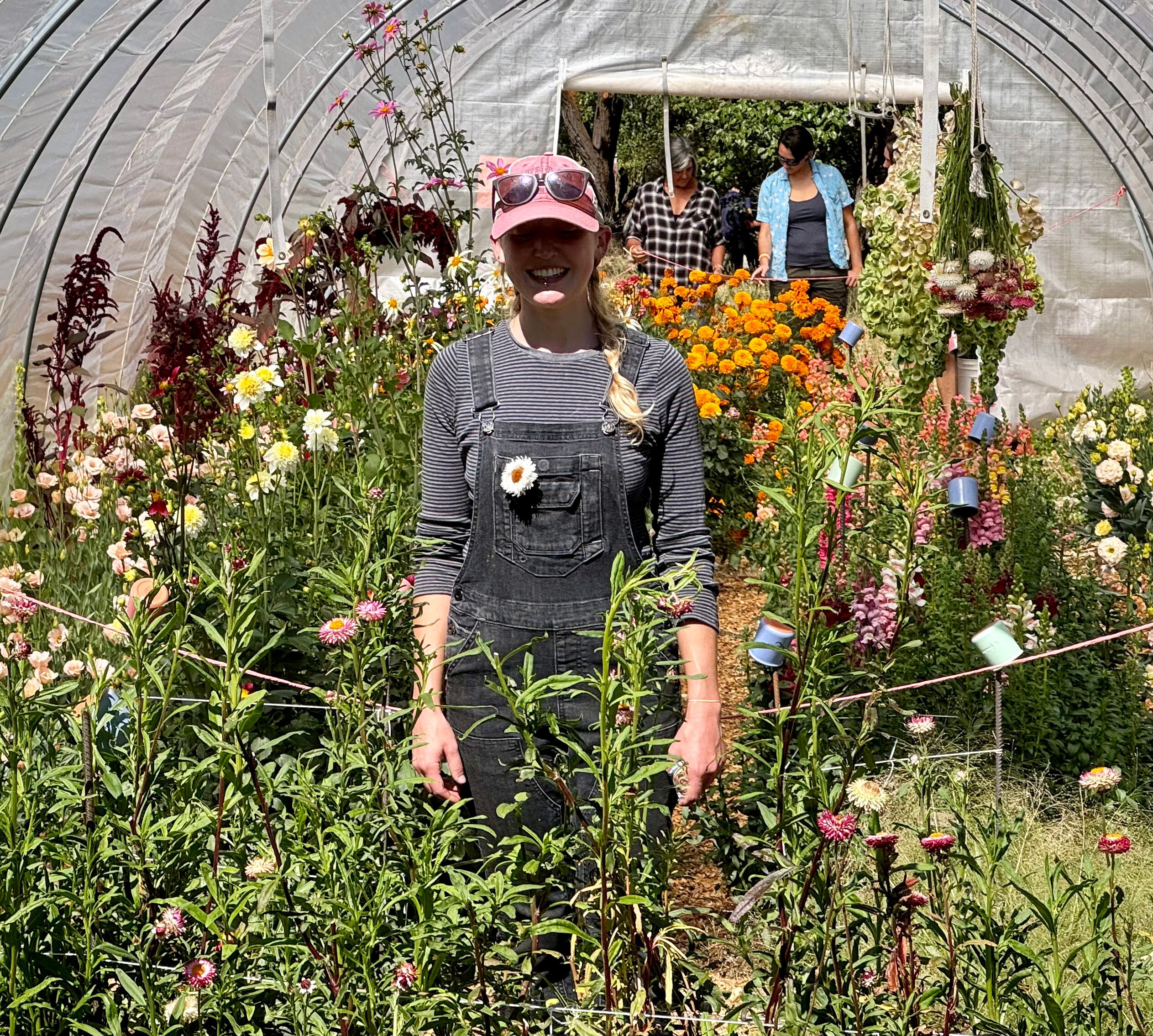 Cameron, pictured above in front of one of three hot houses at the property, works on the farm to make sure everything is watered, seeds are saved, dyes are prepared properly, and flowers are harvested when they are ready for market.