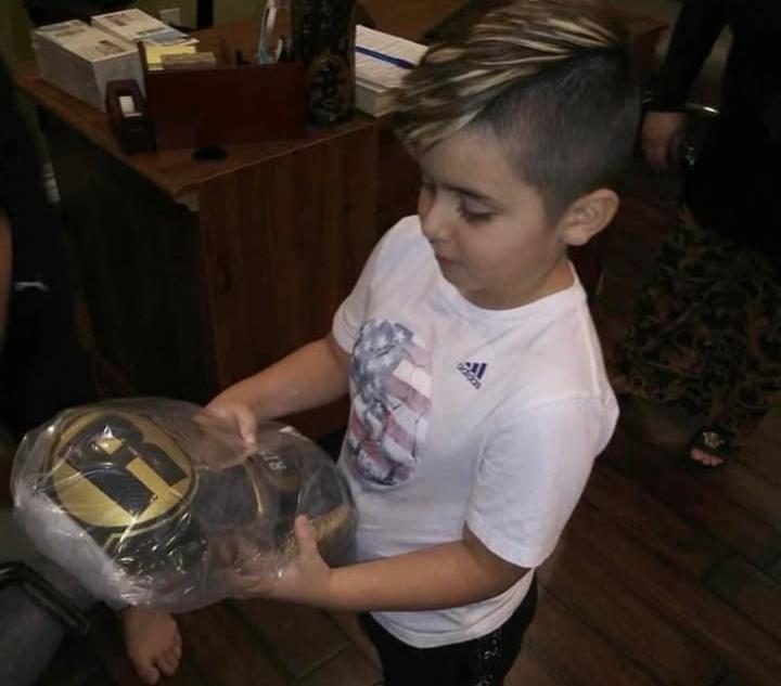 Max receives boxing gloves at 7 years old. Credit: Janett Abdulnour.