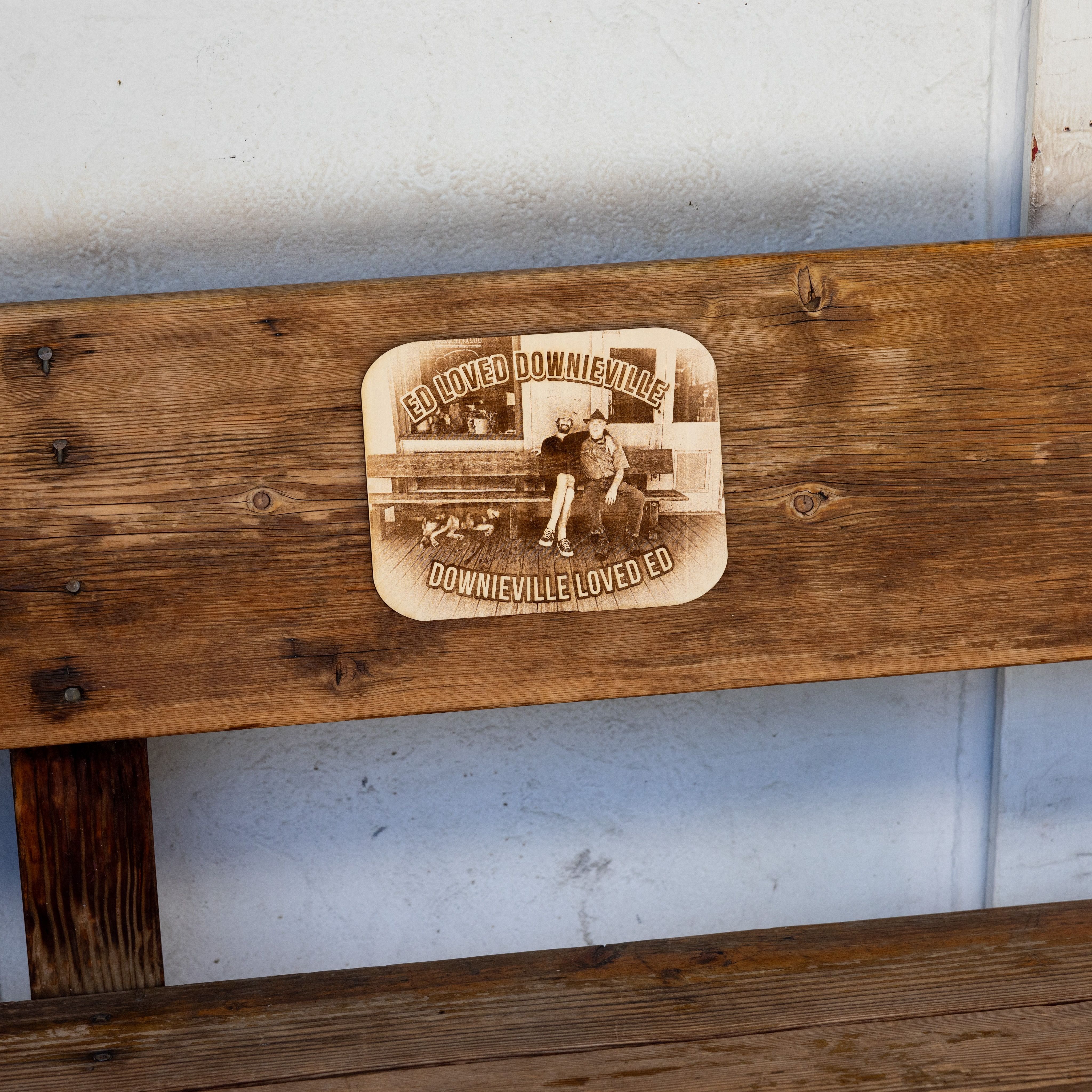 The unveiled plaque features (left to right) Ed’s dog Finn, Evan Sanderson, and Ed Sanderson