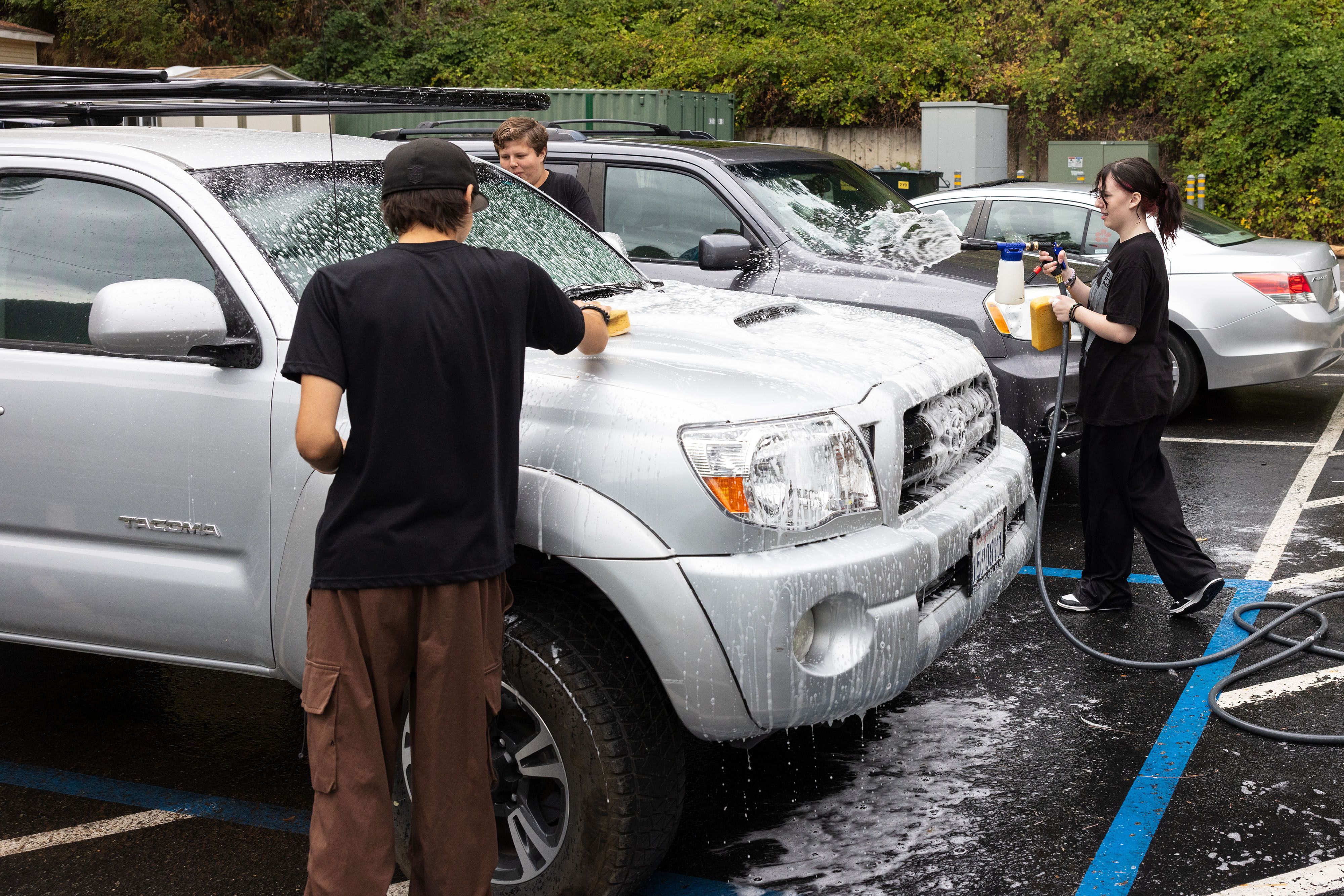 Downieville High School seniors wash a pickup truck in the school’s parking lot.