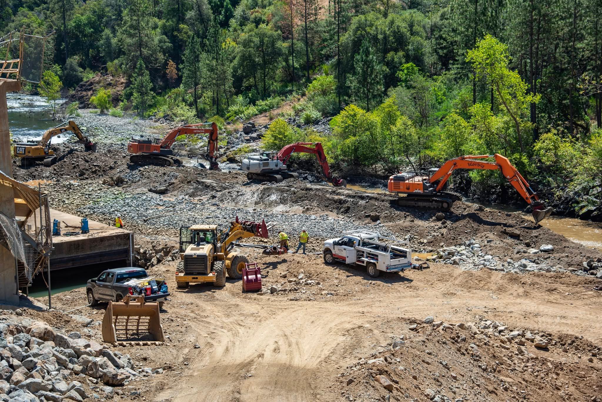 Excavators remove sediment from the riverbank below the New Colgate Powerhouse. The agency says the work causes temporary cloudiness in the river. Photo: Alex Boesch/Yuba Water Agency.
