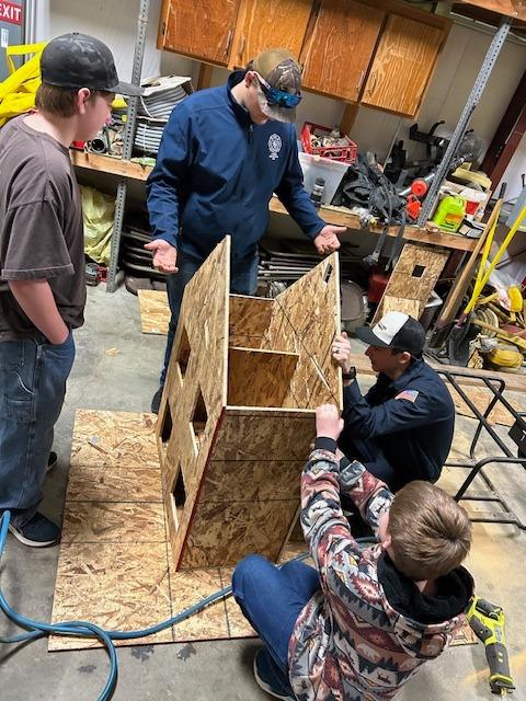 The scale model is constructed with help from cadets