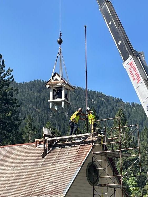The bell is lifted atop the Sierra City schoolhouse