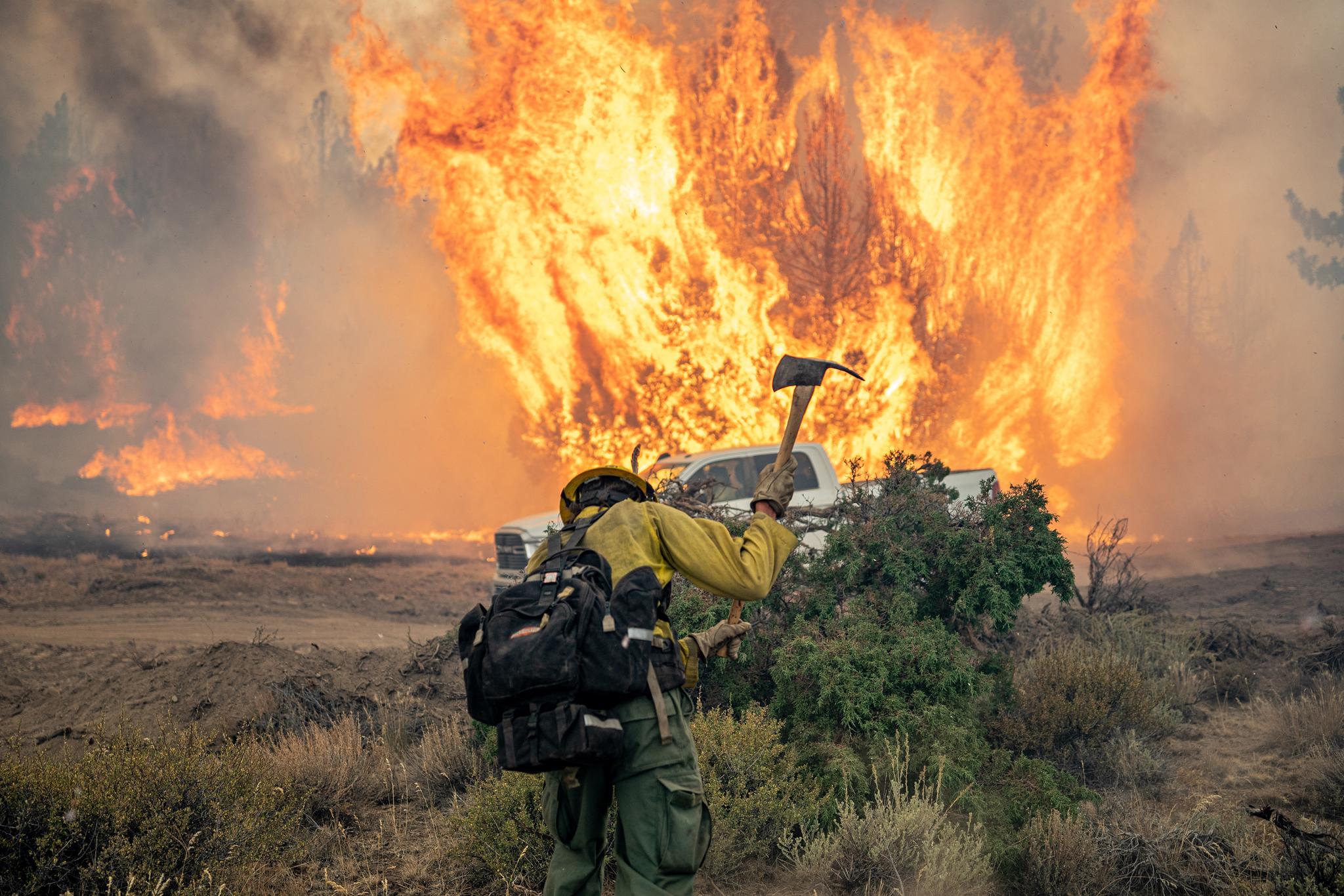 A hand crew member works on establishing a fire break during the Dixie Fire in 2021. Photo by Joe Bradshaw, Bureau of Land Management.